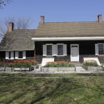View of the rear (south) side of the house, with raised garden beds and natural amphitheater
