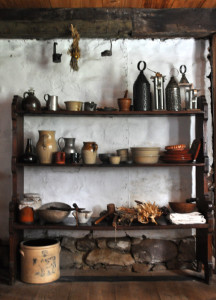 A collection of period and reproduction dishes and other kitchen tools as displayed in the Wyckoff farmhouse's 17th-century kitchen